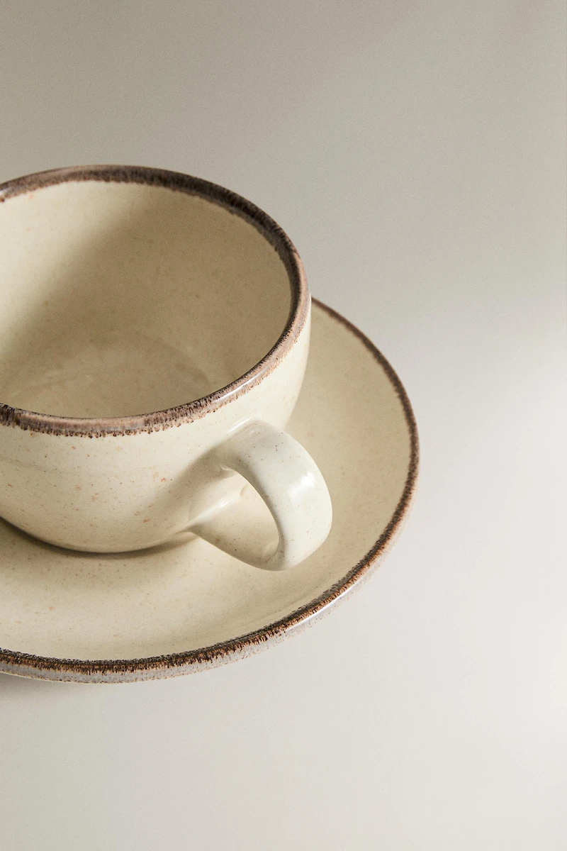 STONEWARE TEACUP AND SAUCER