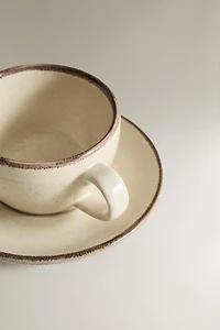 STONEWARE TEACUP AND SAUCER