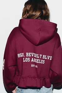 RUFFLED VARSITY SWEATSHIRT
