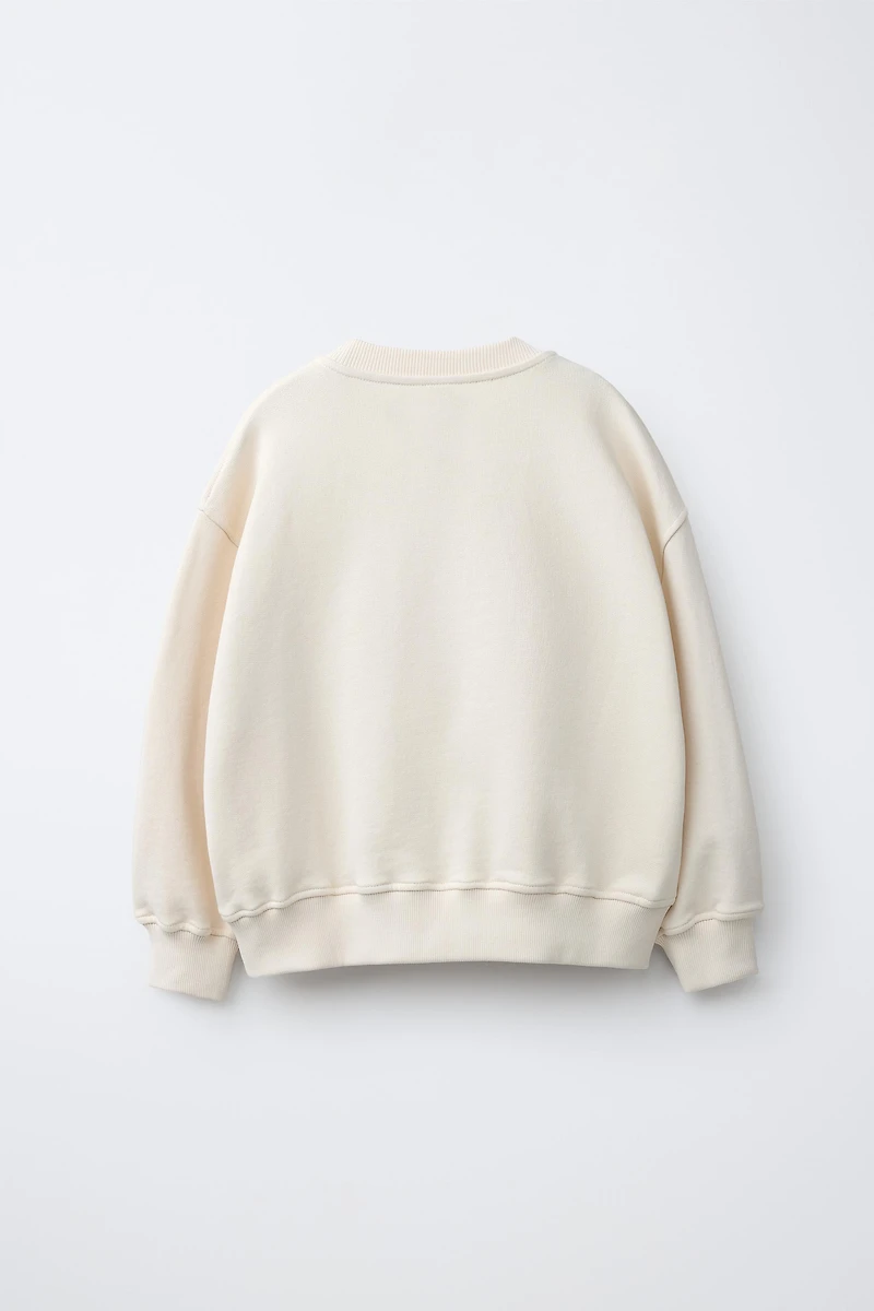 EMBROIDERED INSET SWEATSHIRT