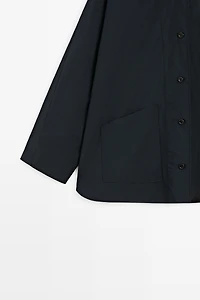 Jacket with buttoned collar strap