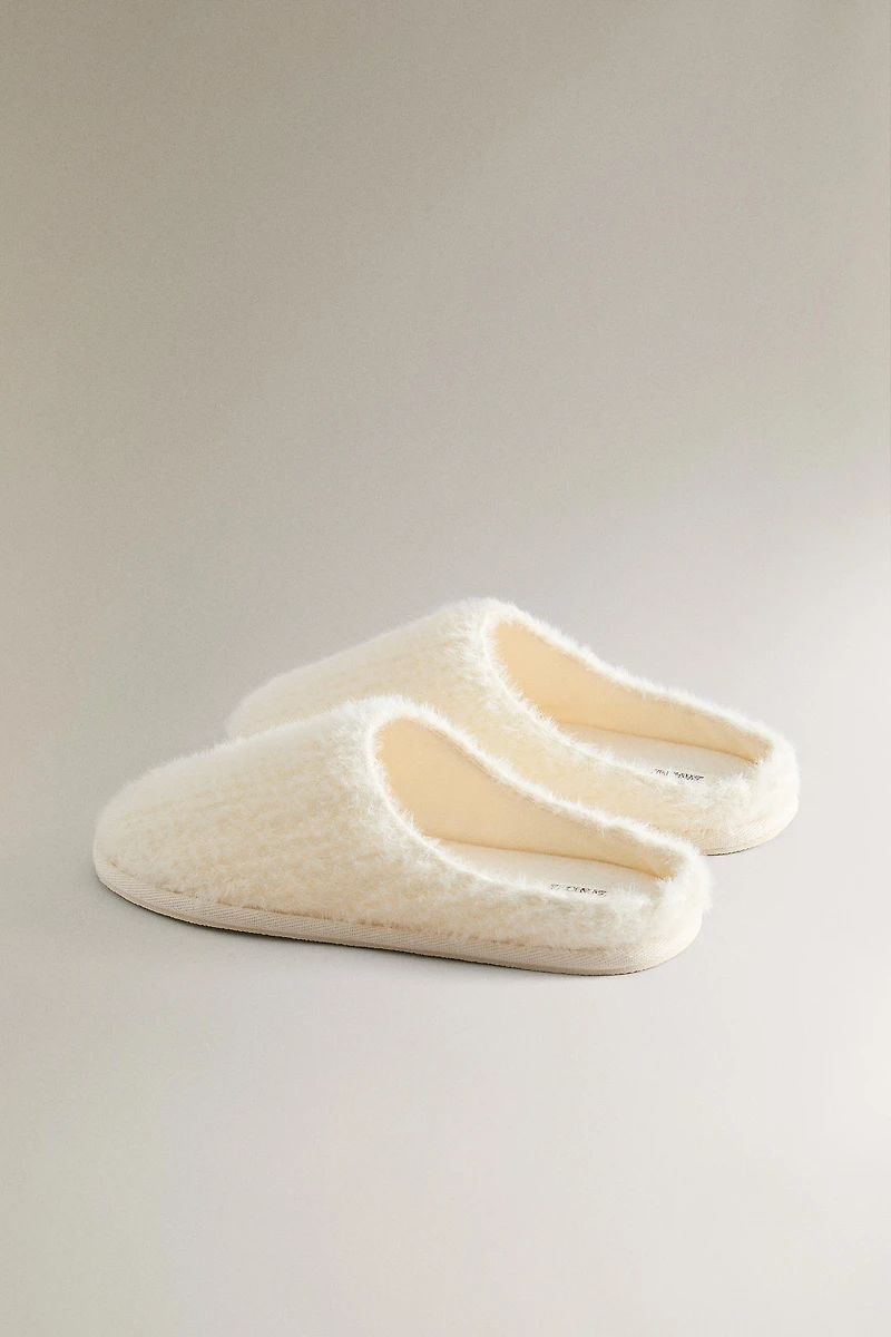 SLIPPERS WITH BRAIDED FAUX FUR DETAIL