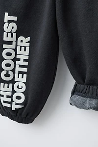 FLOCKED TEXT JOGGER PANTS