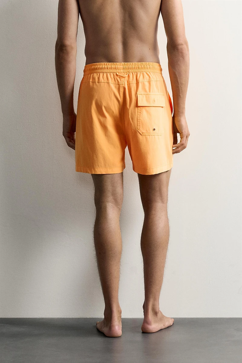 WASHED EFFECT LONG SWIM TRUNKS