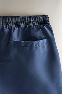 SHORT DE BAIN UNI À CONTRASTE