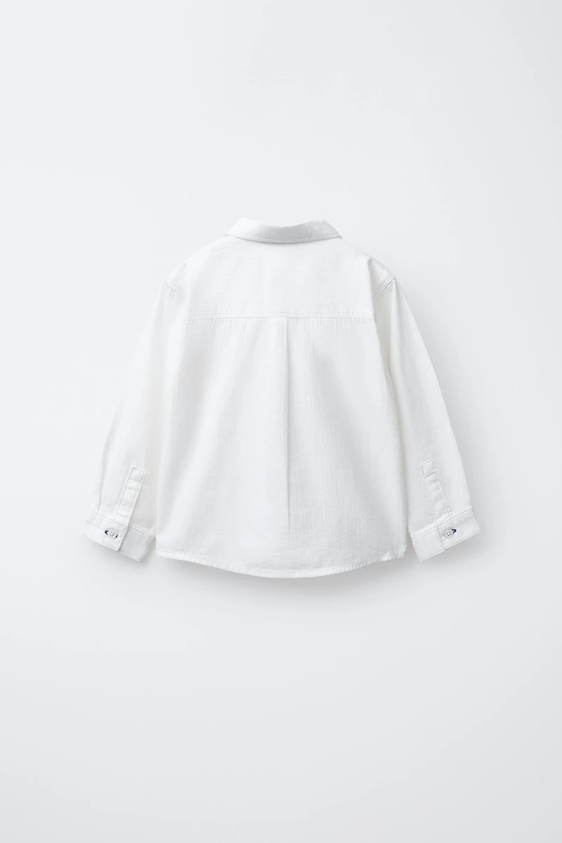 CHEMISE UNIE À POCHE