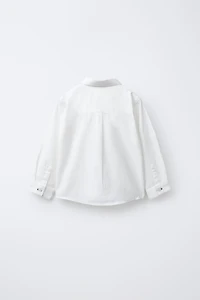 CHEMISE UNIE À POCHE