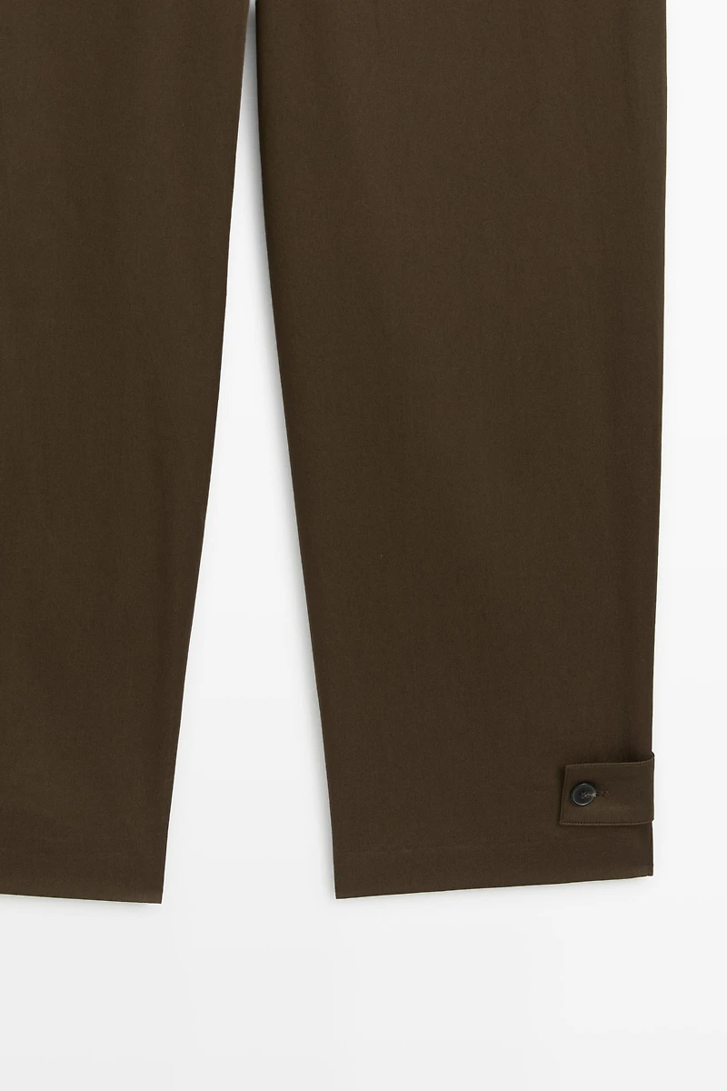 Pants with button-tab hem detail