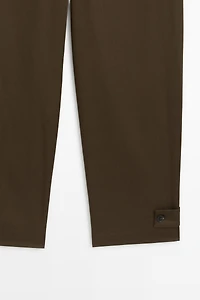 Pants with button-tab hem detail