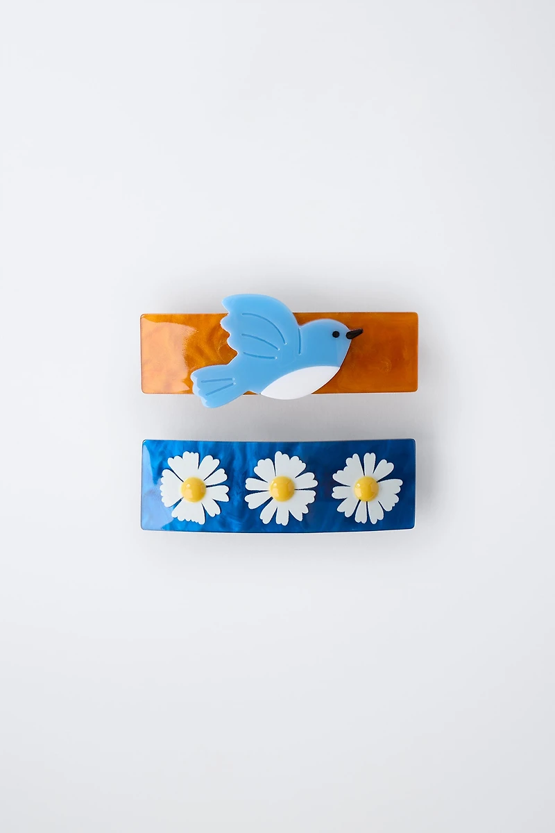 LOT DE DEUX BARRETTES À FLEURS ET OISEAU