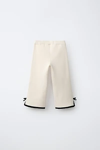 FLARED KNIT PANTS WITH BOWS