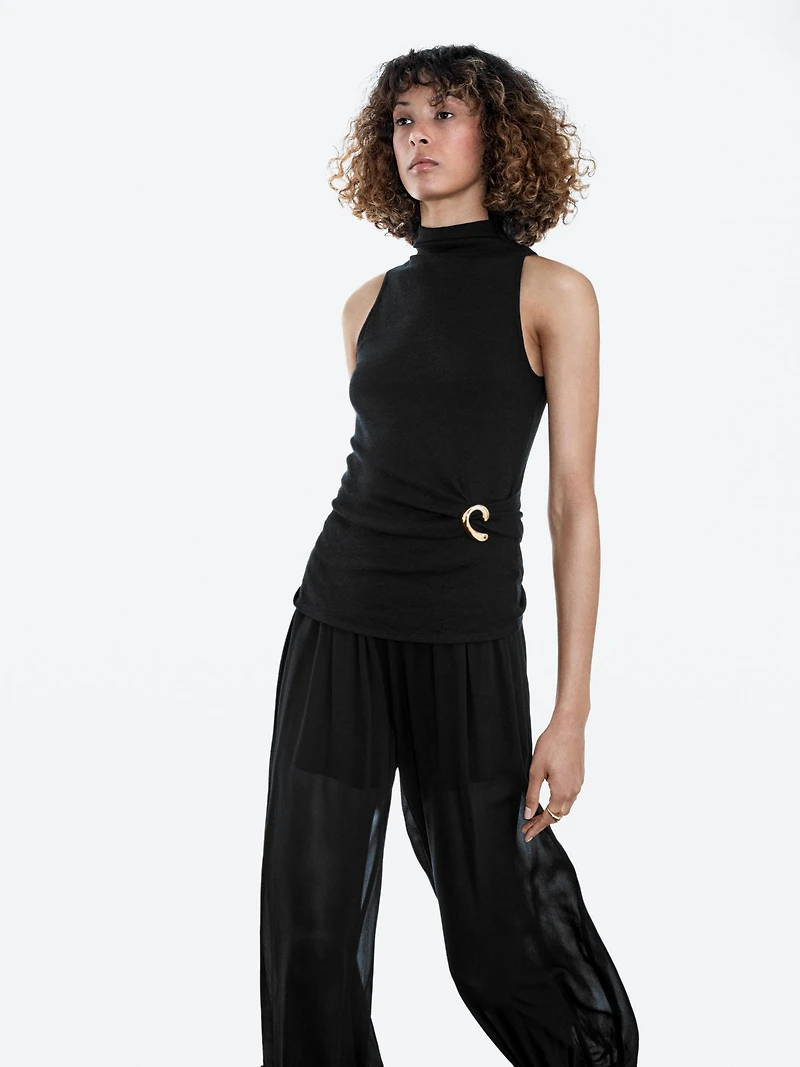 Funnel neck top with brooch detail