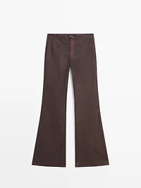 Waxed flare fit trousers