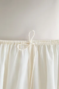 SMOCKED TROUSERS WITH LACE AND DRAWSTRINGS