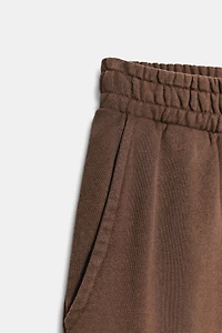 WASHED EFFECT FLEECE PANTS WITH STUDS