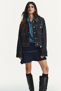 JUPE ASYMÉTRIQUE À VOLANT ET CLOUS