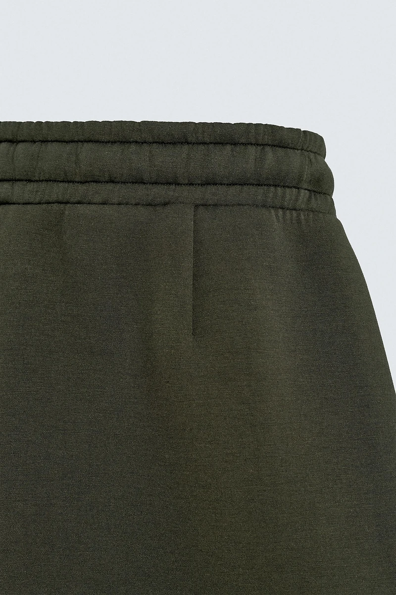 NEOPRENE EFFECT PLEATED LONG BERMUDA SHORTS