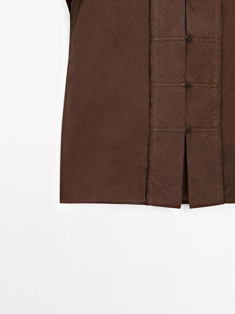 Veste sans manches plastron boutonné