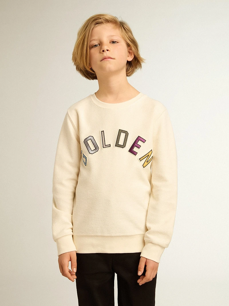 Sweatshirt aged white with multicolor Golden lettering on the front
