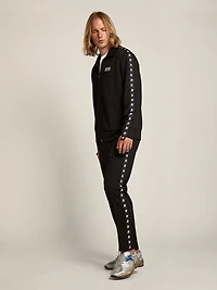Men's black joggers with white stars on the sides