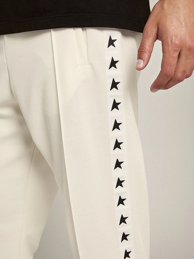Men's white joggers with black stars on the sides