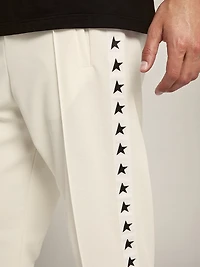 Men's white joggers with black stars on the sides