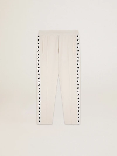 Men's white joggers with black stars on the sides