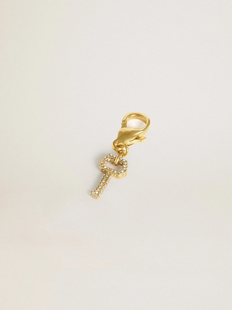 Key-shaped charm in gold-colored brass with crystals