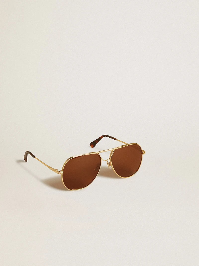 Aviator style sunglasses with gold frame and brown lenses
