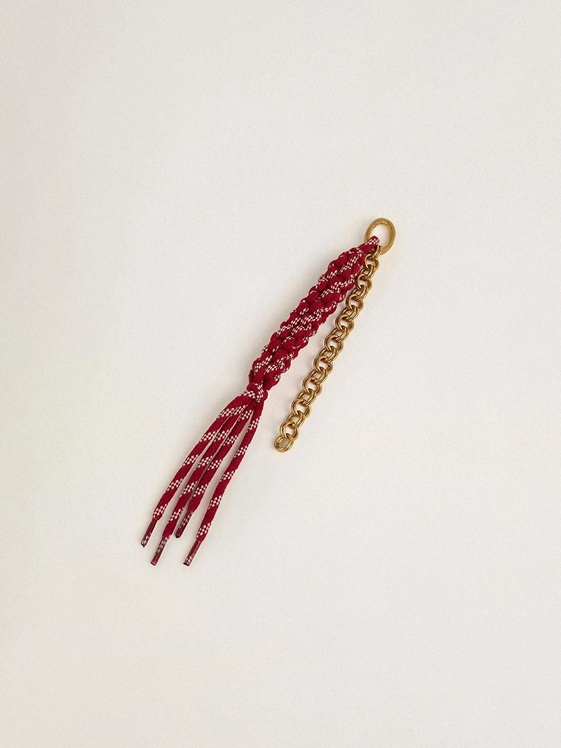 Charm with red knotted laces