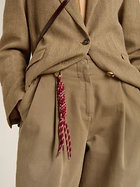 Charm with red knotted laces