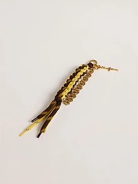 Charm with yellow and brown knotted hiking laces with chain