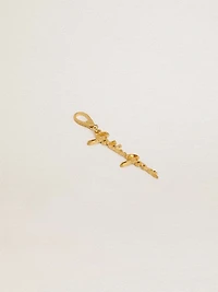 Gold-colored brass charm with Golden Goose signature