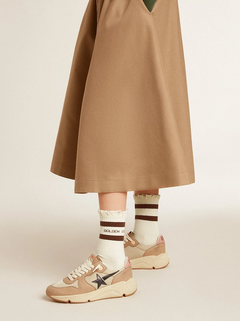 Worn-white socks with distressed details and brown stripes