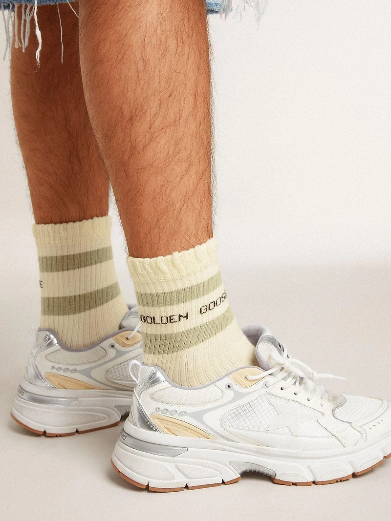 Worn-white socks with distressed details and sage-green stripes