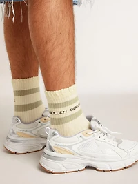 Worn-white socks with distressed details and sage-green stripes