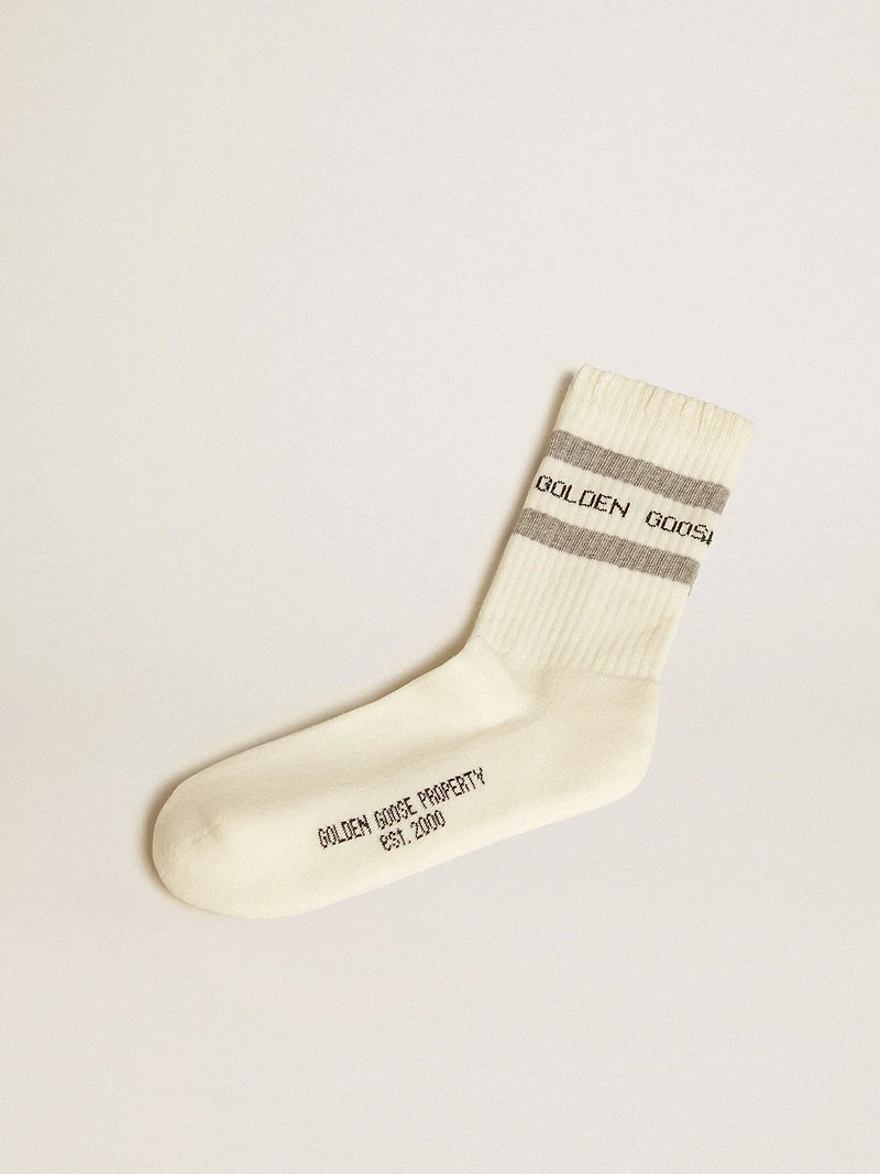 Worn-white socks with distressed details and sage-green stripes