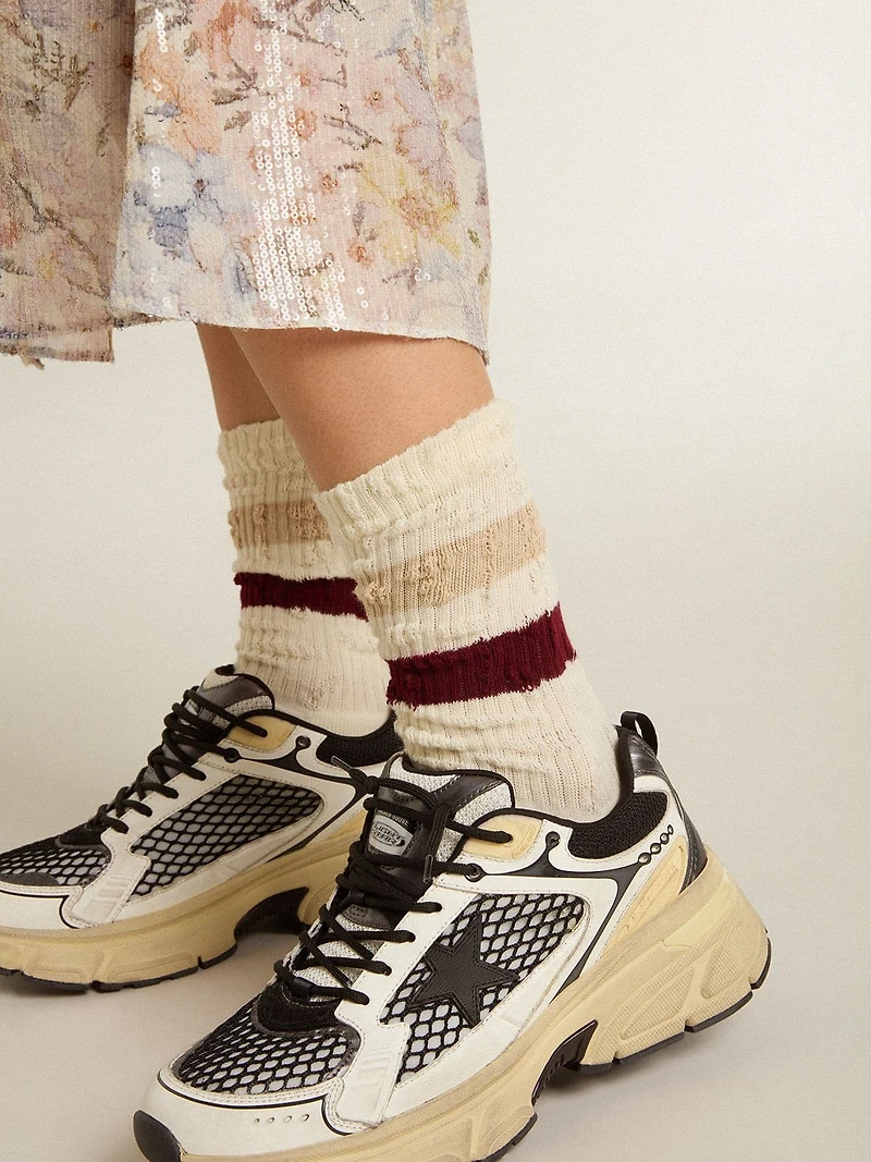 Worn-white socks with distressed details and beige burgundy stripes