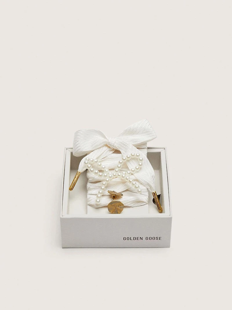Skins "Sparkling" cream striped laces embellished with beaded charm and golden charm