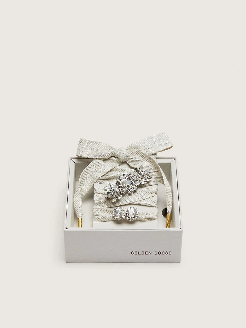 Skins "Sparkling" cream and silver herringbone laces embellished with two charms