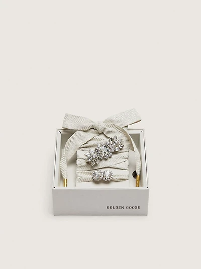 Skins "Sparkling" cream and silver herringbone laces embellished with two charms