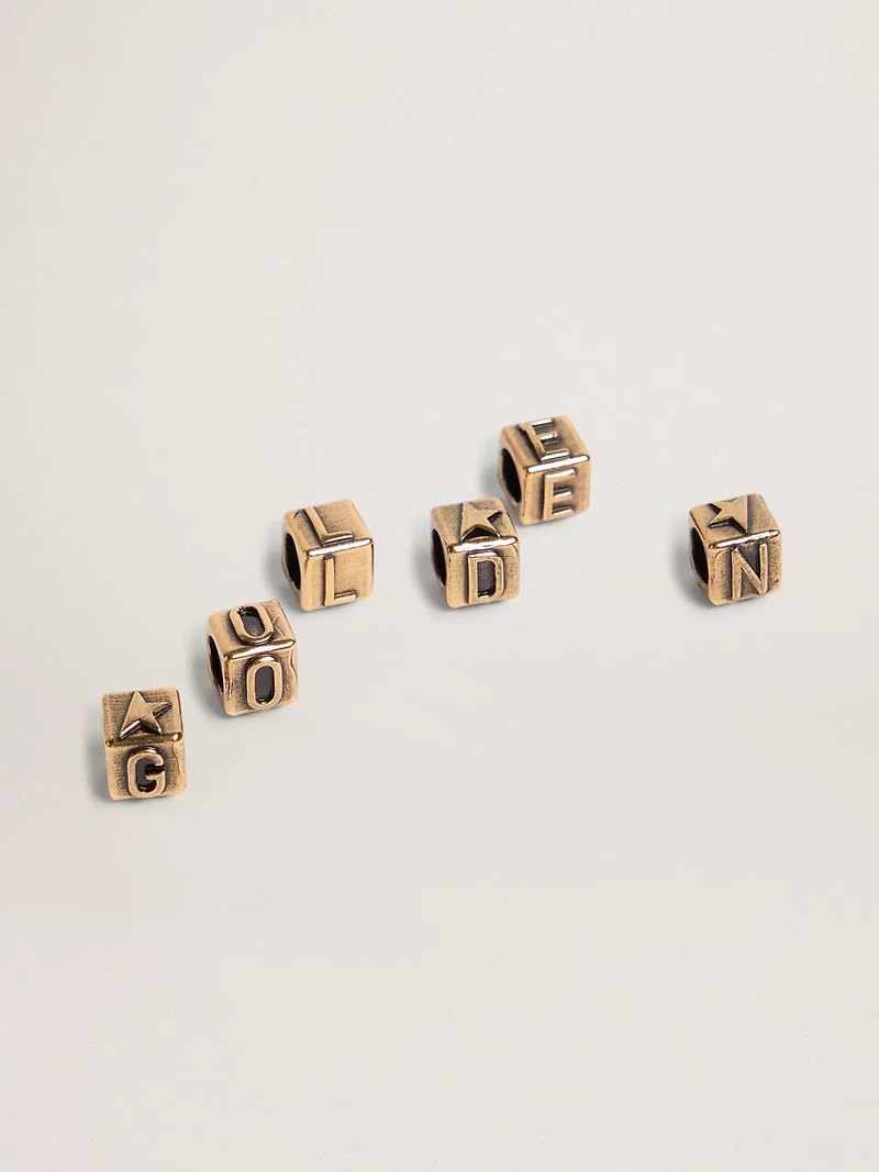 Women's cubic charms in antique gold color with letters of the alphabet