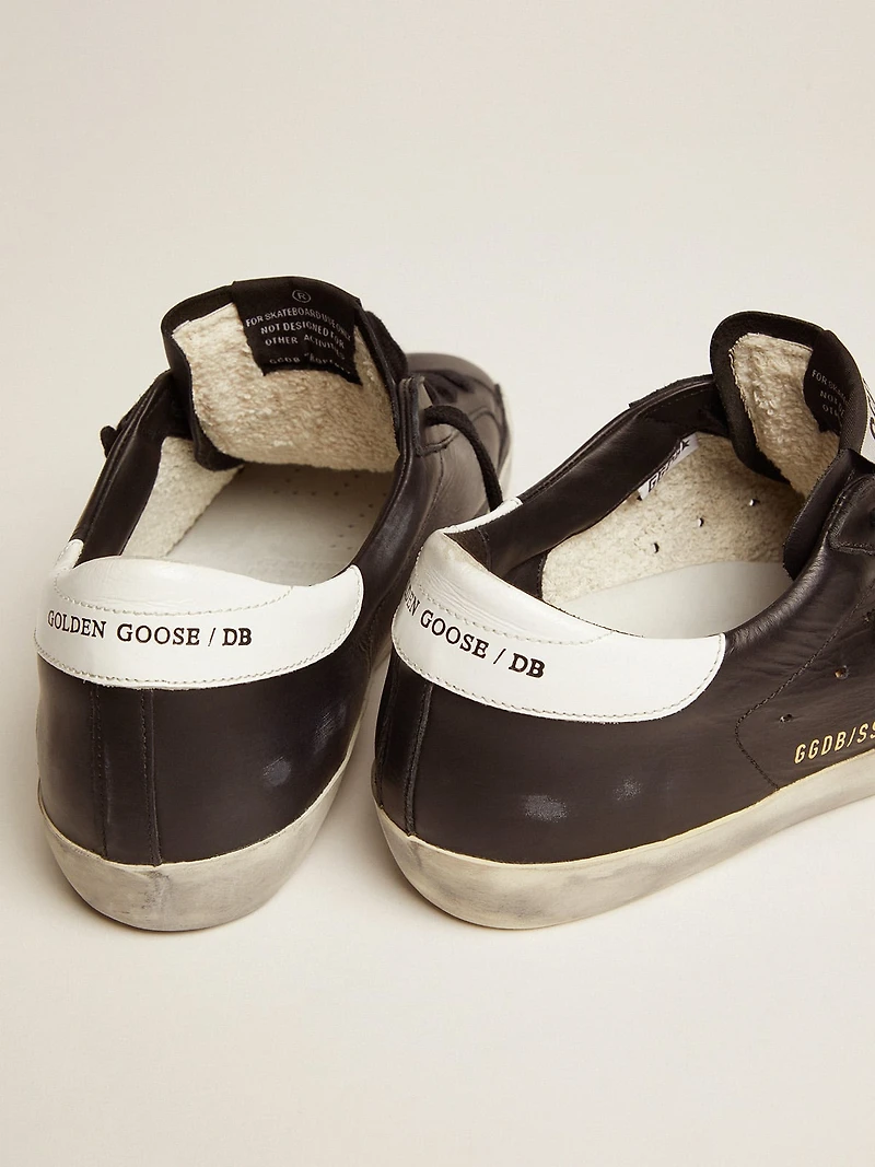 Women’s Super-Star black leather with white star and heel tab