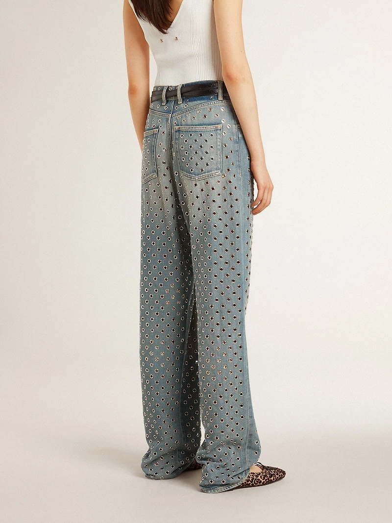 Women's washed jeans with all-over eyelets
