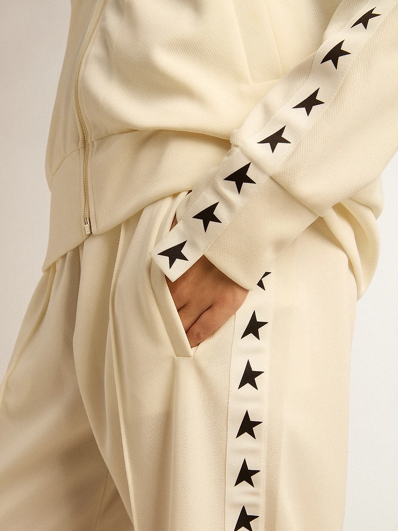 Women’s white zipped sweatshirt with strip and black stars