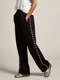 Women’s black joggers with white stars on the sides
