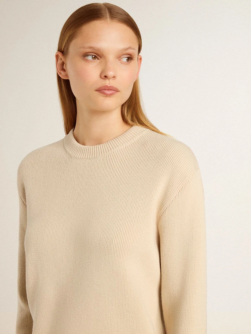 Women's beige sweater with 'Golden' lettering on the back