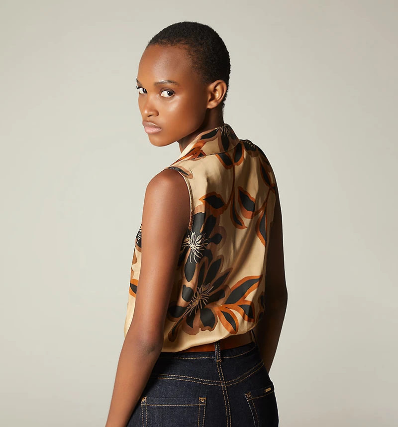 SLEEVELESS CROSSOVER BODYSUIT