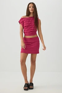 Haut court asymétrique à volants