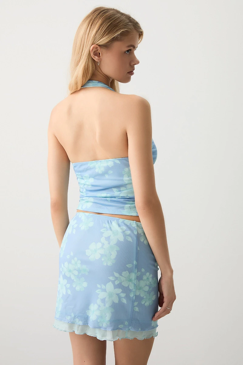 Jupe courte en maille filet doublé fleuri